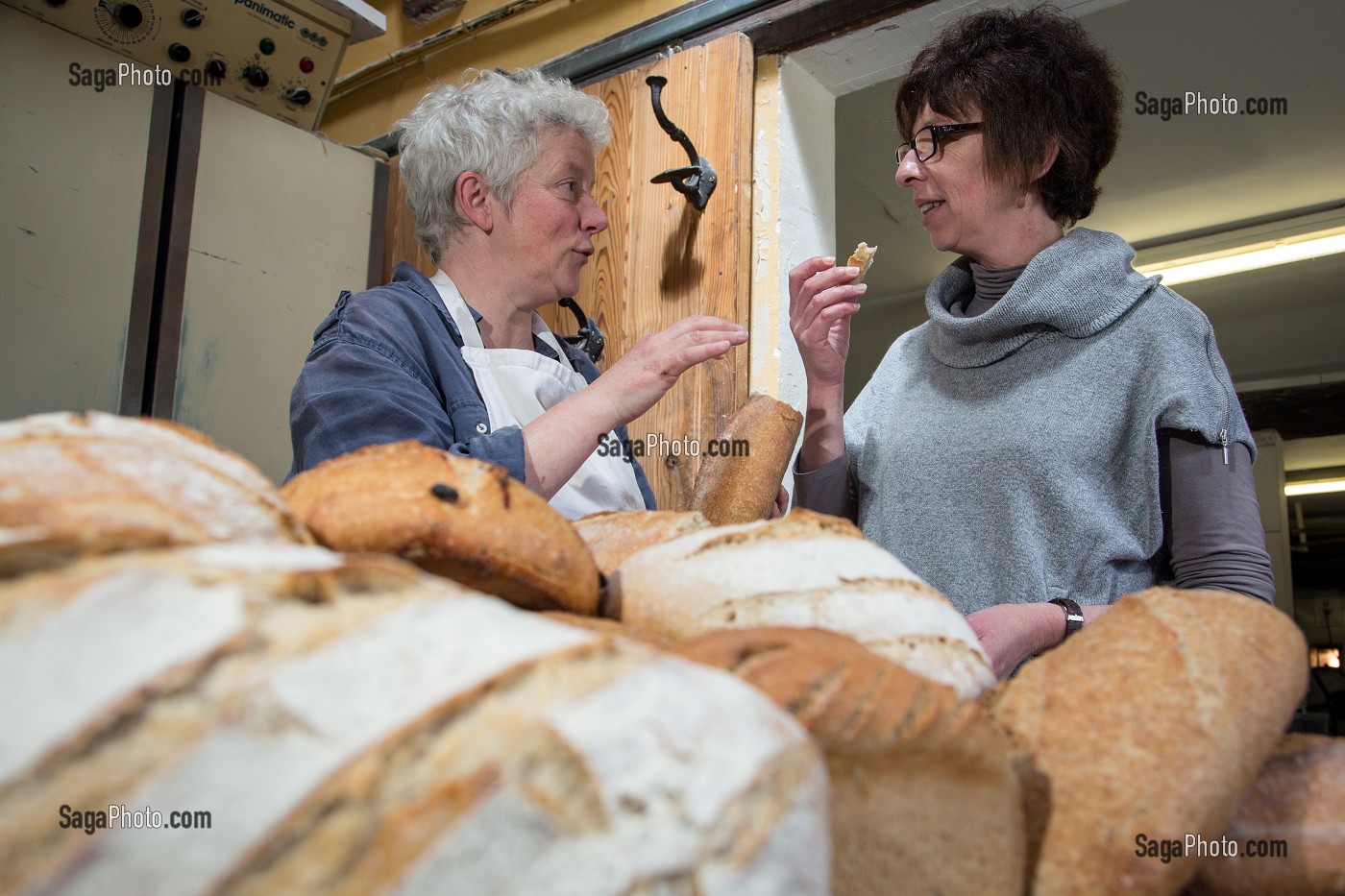BLANDINE ZOUTARD FAISANT GOUTER SON PAIN BIO A NATHALIE DE WEVER, COMMERCANTE ET ADHERENTE DU MOUVEMENT LOCAVORE, DANS SA BOULANGERIE DE PAIN BIO, FERME DE SAINT-MAMERT, BUIS-SOUS-DANVILLE, EURE (27), FRANCE 