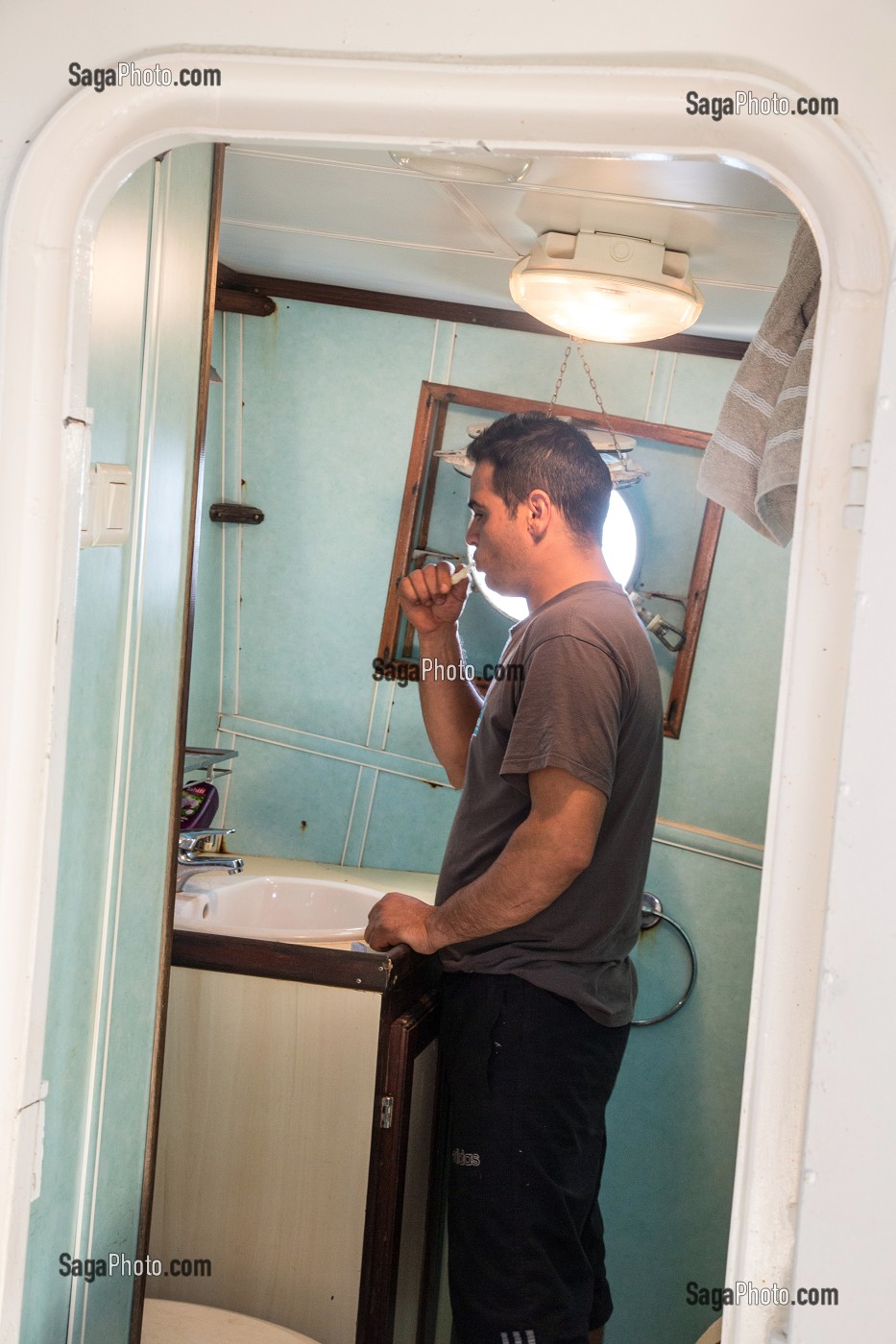 NIZAR DANS LA CABINE DE TOILETTES, PECHE EN MER SUR UN CHALUTIER A LA LANGOUSTINE 'LE QUENTIN-GREGOIRE' AU LARGE DES SABLES-D'OLONNE (85), FRANCE 