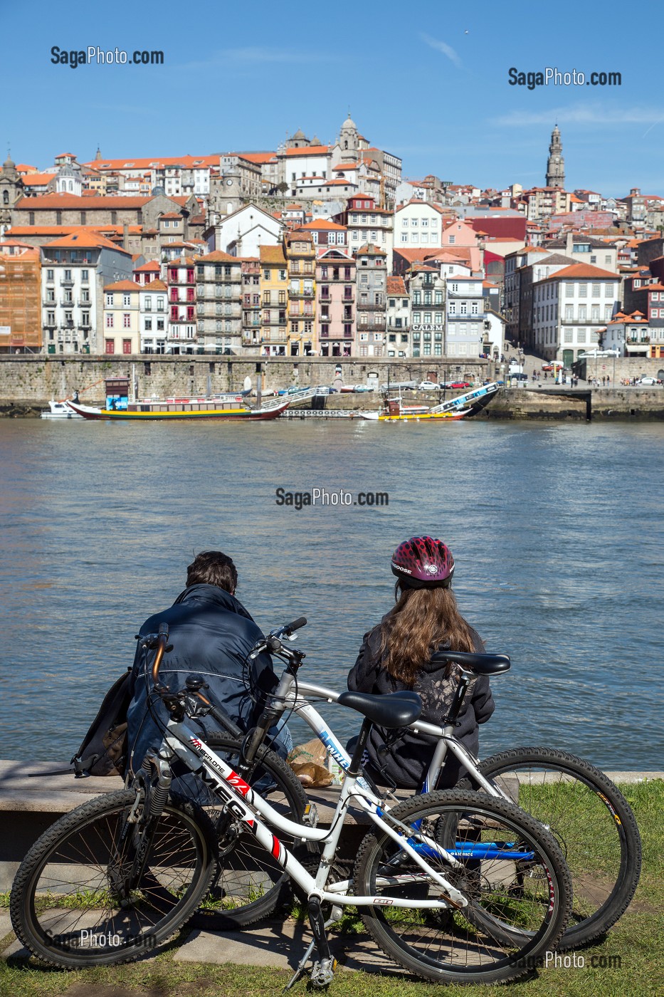 COUPLE DE CYCLISTES SUR LES BERGES DU DOURO FACE A LA VILLE DE PORTO, VILA NOVA DE GAIA, PORTUGAL 