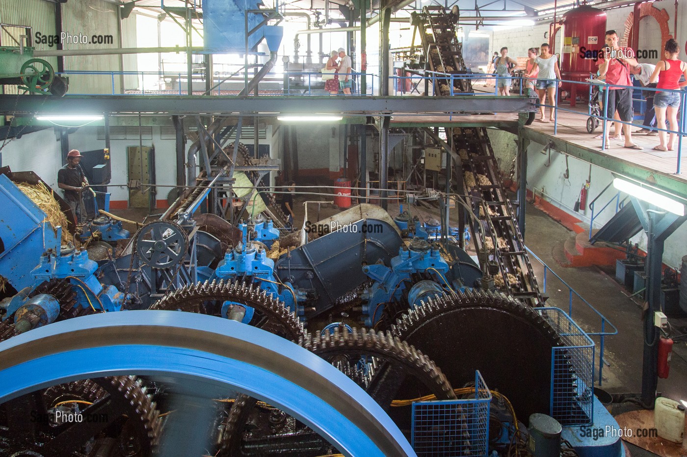 VISITE TOURISTIQUE DEVANT LA MACHINE A BROYER ET EXTRAIRE LE JUS DE CANNE A SUCRE, DISTILLERIE DE RHUM LA FAVORITE, FORT-DE-FRANCE, MARTINIQUE, ANTILLES FRANCAISES, FRANCE 