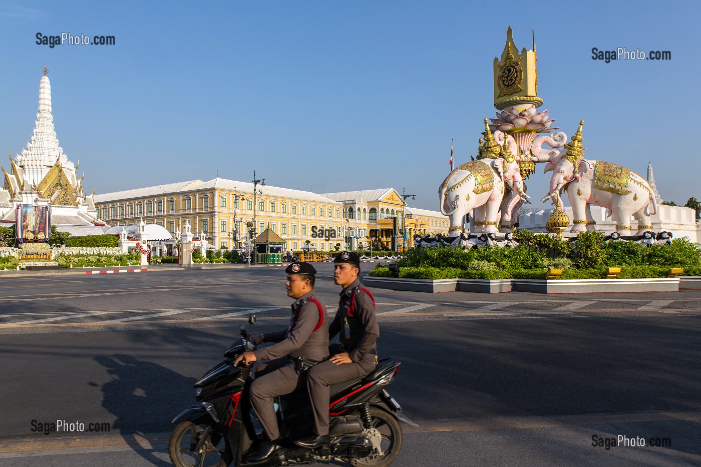 MILITAIRES EN SCOOTER PASSANT DEVANT LES ELEPHANTS ROSES, STATUES A LA SYMBOLIQUE RELIGIEUSE, BOUDDHISTE, A COTE DU PALAIS ROYAL, BANGKOK, THAILANDE, ASIE 