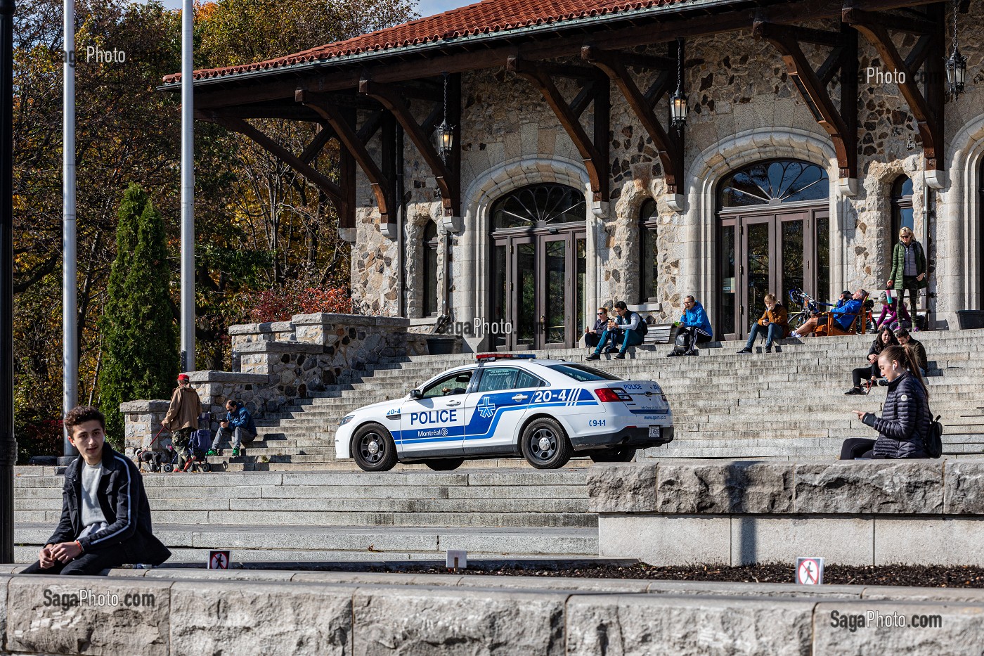 VOITURE DE POLICE EN PATROUILLE ET TOURISTES EN BALADE AU BELVEDERE KONDIARONK DEVANT L'OBSERVATOIRE DU MONT-ROYAL, VILLE DE MONTREAL, QUEBEC, CANADA 