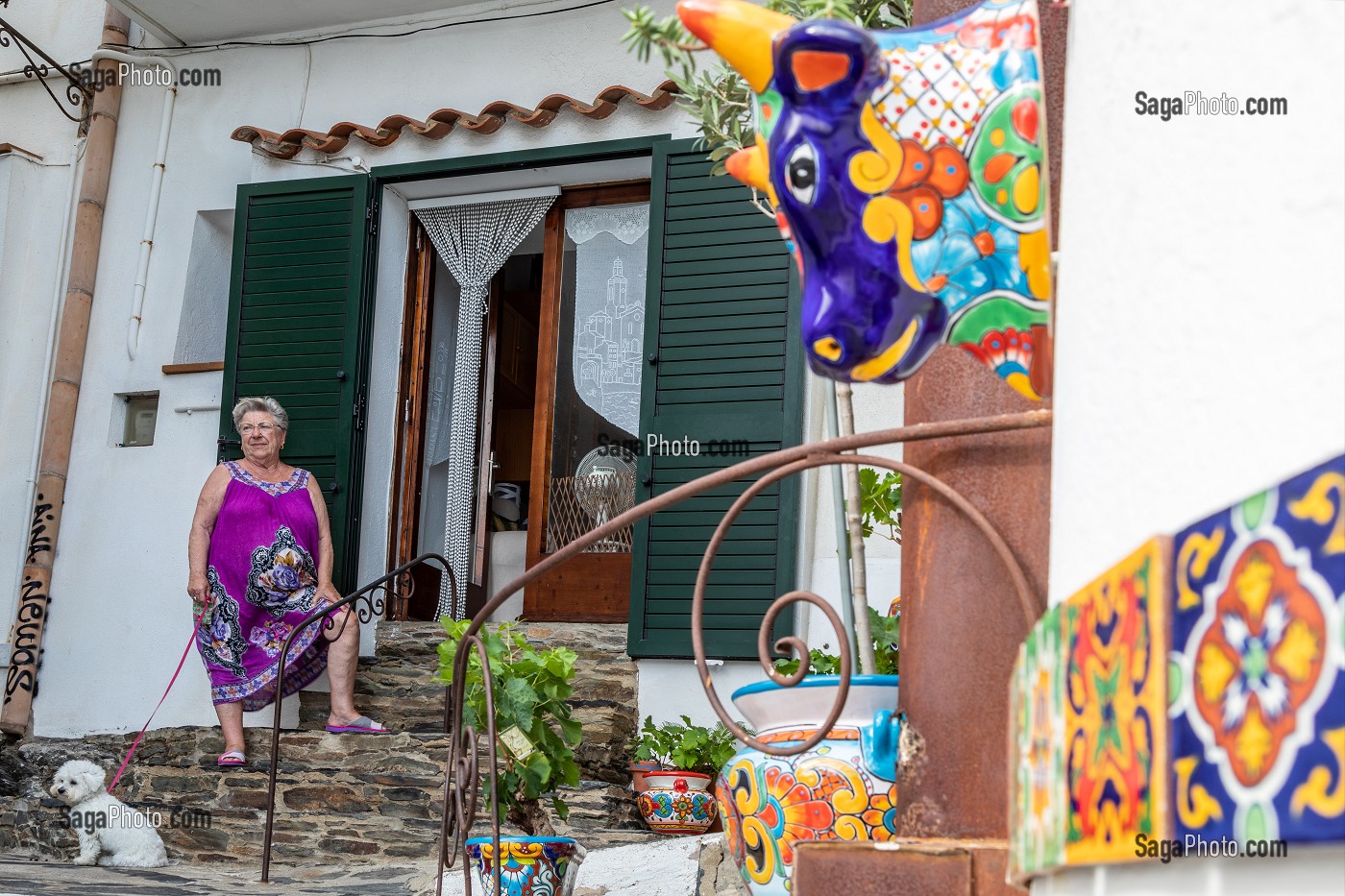 HABITANTE AVEC SON CHIEN DEVANT SA MAISON DECOREE DE MOSAIQUE, VILLAGE OU A VECU SALVADOR DALI, CADAQUES, COSTA BRAVA, CATALOGNE, ESPAGNE 