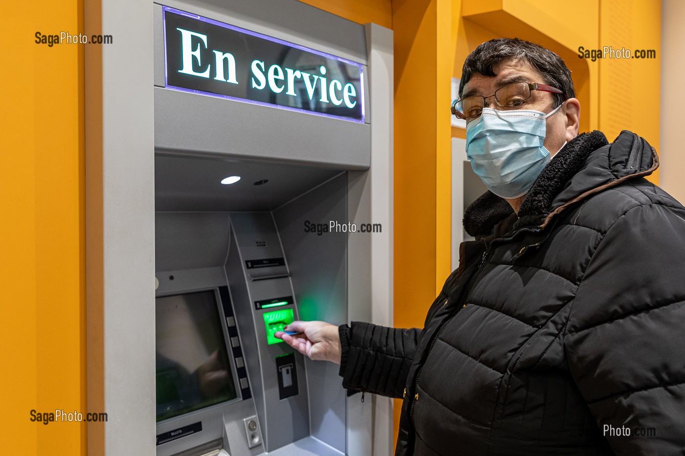 RESIDENTE AUTONOME DEVANT LE DISTRIBUTEUR DE BILLETS, ADULTES EN SITUATION DE HANDICAP INTELLECTUEL MOYEN, RESIDENCE DU MOULIN DE LA RISLE, RUGLES, EURE, NORMANDIE, FRANCE 