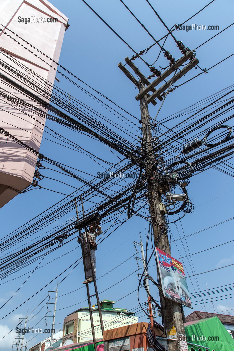 EMPLOYE AU TRAVAIL DANS L'ENCHEVETREMENT DE FILS ELECTRIQUES ET TELEPHONIQUES TYPIQUES DU RESEAU THAILANDAIS, BANG SAPHAN, THAILANDE, ASIE 