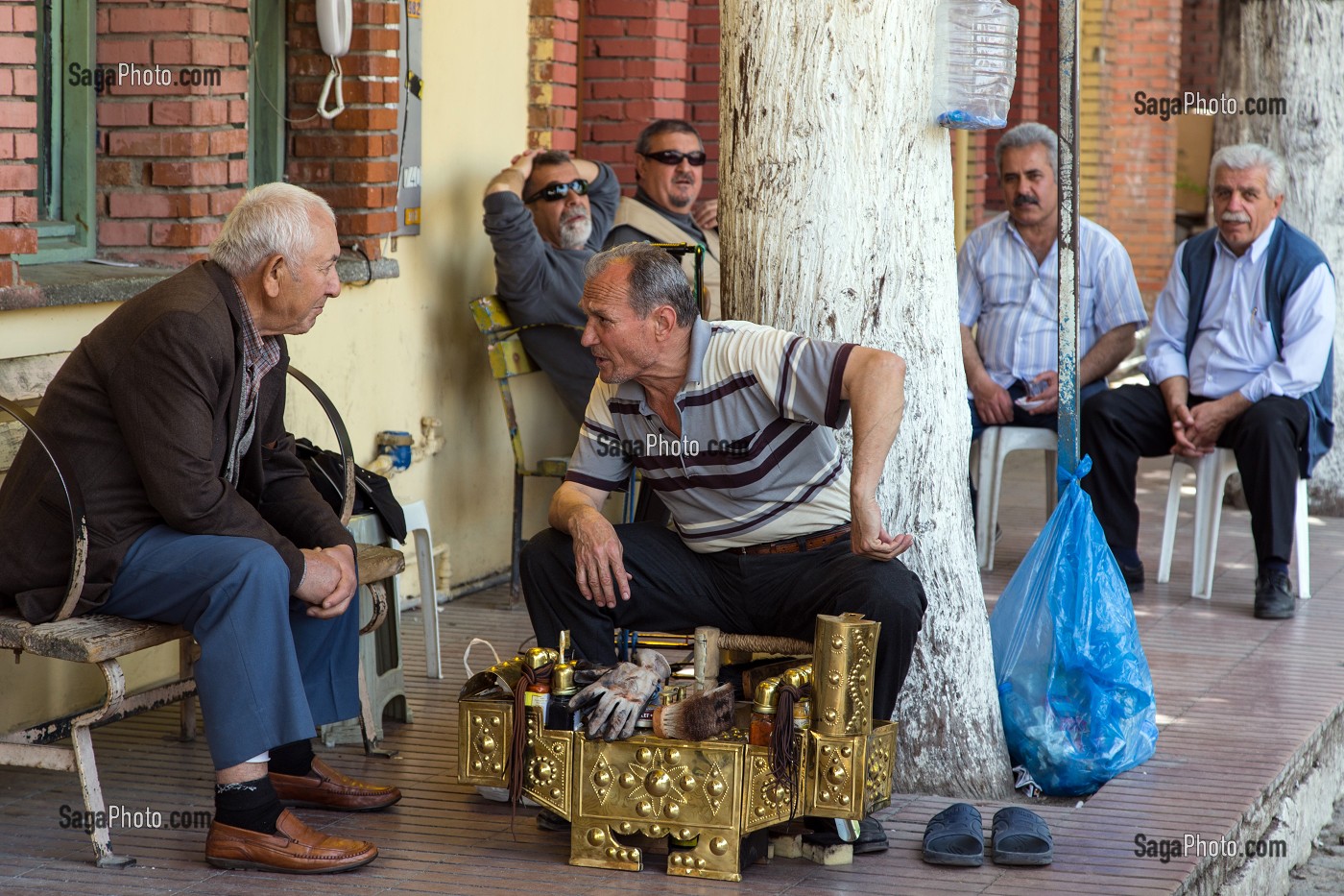 DISCUSSION ENTRE HOMMES, CHAUFFEURS DE TAXI ET LE CIREUR DE CHAUSSURES, VILLAGE DE PECHEURS DE FOCA SUR LA MER EGEE, RIVIERA DES OLIVIERS, NORD D’IZMIR, TURQUIE 
