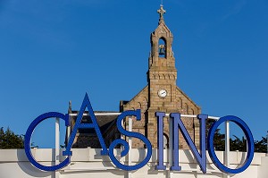 ENSEIGNE DU CASINO ET EGLISE SAINT-PIERRE-SAINT-PAUL EN ARRIERE-PLAN, PLENEUF-VAL-ANDRE, (22) COTES-D’ARMOR, BRETAGNE, FRANCE 