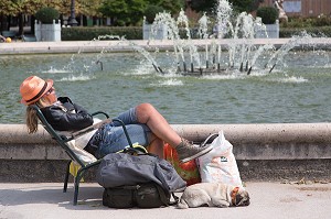 FEMME FAISANT LA SIESTE AU SOLEIL, JARDIN DU PALAIS ROYAL, PARIS (75), FRANCE 