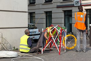 TRAVAUX DE RACCORDEMENT DE LA FIBRE OPTIQUE POUR LE RESEAU INTERNET ET TELEPHONE DEVANT LA GARE MONTPARNASSE, PLACE DE CATALOGNE, PARIS (75), FRANCE 