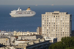 PAQUEBOT EN APPROCHE DU PORT DU HAVRE DERRIERE LES IMMEUBLES D'ARCHITECTURE D'AUGUSTE PERRET CLASSEE AU PATRIMOINE MONDIAL DE L'UNESCO, PORTE OCEANE, LE HAVRE, SEINE-MARITIME (76), NORMANDIE, FRANCE 