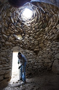 NETTOYAGE DE L'INTERIEUR D'UNE BORIE,BALADE INSOLITE SUR LES TERRASSES EN PIERRES SECHES ET DE BORIES AU MOULIN DU MAS DES BORIES, DOMAINE OLEICOLE, CHEMIN DE LA COUSTADE, (13) SALON-DE-PROVENCE, REGION SUD, PROVENCE ALPES COTES D'AZUR, FRANCE 