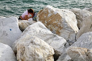 COUPLE D'AMOUREUX SUR LA PLAGE DE MARINA DI CARRARA BORDEE DE BLOC DE MARBRE BLANC, CAPITALE MONDIALE DU MARBRE, CARRARE, TOSCANE, ITALIE 