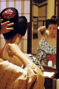 MAQUILLAGE TRADITIONNEL (DORAN) D’UNE MAIKO (APPRENTIE GEISHA), APPLICATION DU FARD BLANC (SHIRONURI) SUR LA NUQUE AVEC UN PINCEAU DE BAMBOU (BURASHI), LA COIFFURE DE LA MAIKO EST UN CHIGNON EN FORME DE PECHE FENDUE (WARESHINOBU) ORNE DE RUBANS EN SOIE (KANOKO), QUARTIER DE GION, KYOTO, JAPON, ASIE 