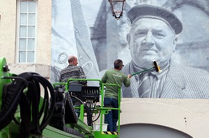 COLLAGE AVEC UNE NACELLE DES PHOTOS GEANTES SUR LES MURS DE LA VILLE POUR LE FESTIVAL CULTUREL RUGL'ART, RUGLES, (27) EURE, FRANCE 