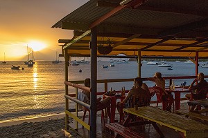 TERRASSE DE CAFE SUR LA PLAGE AU COUCHER DE SOLEIL, GRANDE ANSE D'ARLET, LES-ANSES-D'ARLET, MARTINIQUE, ANTILLES FRANCAISES, FRANCE 