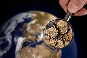 RENAISSANCE, LOUPE POUR GROSSIR UN DETAIL DE LA TERRE AVEC UNE JEUNE POUSSE DE PLANTE, ILLUSTRATION DE LA RENAISSANCE DE LA VIE APRES LA SECHERESSE, EXPOSITION PHOTOGRAPHIQUE ‘TERRE FRAGILE’ MONTRANT L’IMPACT DE L’HOMME SUR LA PLANETE, FRANCE, MONDE 