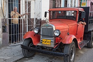 LIVREUR DANS UNE VIEILLE VOITURE AMERICAINE, LA HAVANE, CUBA, CARAIBES 