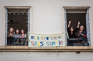 BANDEROLE 'ON VA S'EN SORTIR SANS SORTIR', ISABELLE, INFIRMIERE, OLIVIER ET LEURS TROIS FILLES SOUTIENNENT LES SOIGNANTS A 20H TOUS LES SOIRS ILS APPLAUDISSENT LES SOIGNANTS LORS DU CONFINEMENT DE LA PANDEMIE DU COVID 19, CHARENTON LE PONT, ILE DE FRANCE 