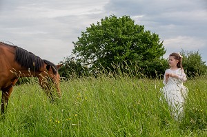 COMPLICITE ENTRE UNE ENFANT ET UN POULAIN, RUGLES, NORMANDIE 